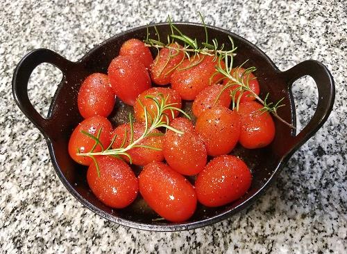 cherry tomatoes and rosemary in a pot