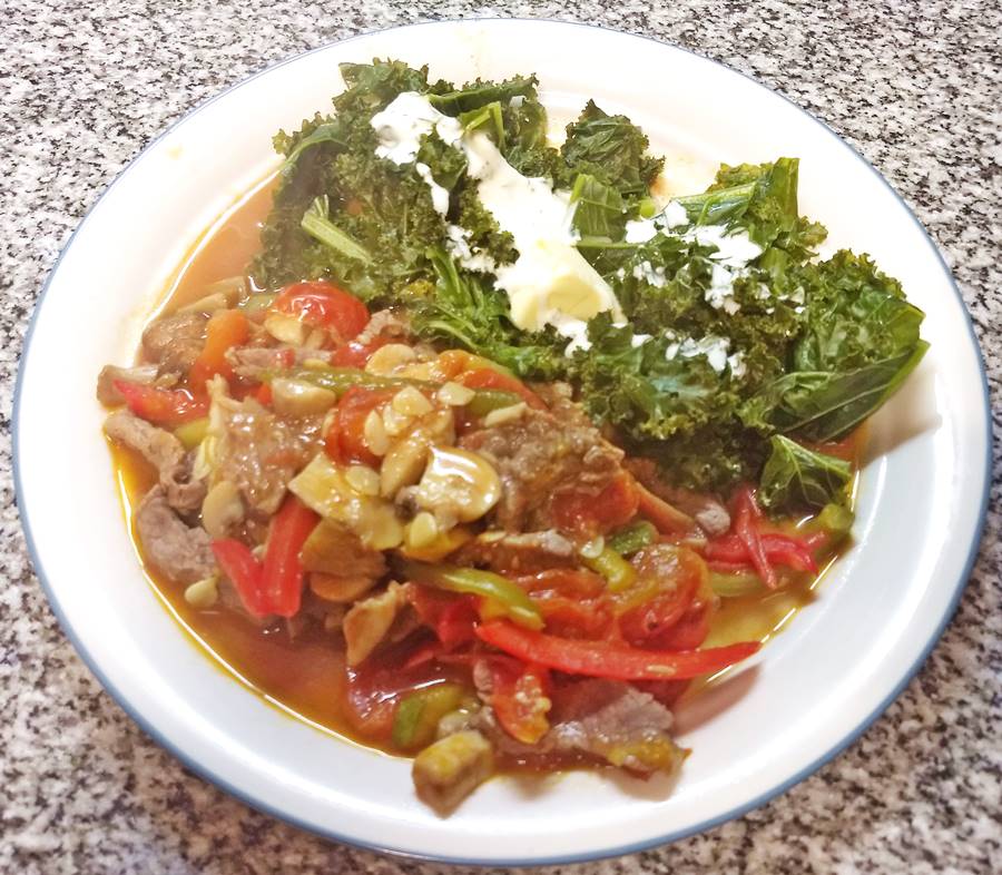 The Beef strips with steamed kale & cream and a veggie wok on a plate