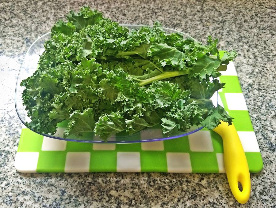 raw kale on a chopping board