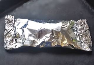 salmon wrapped in aluminium foil ready for the oven