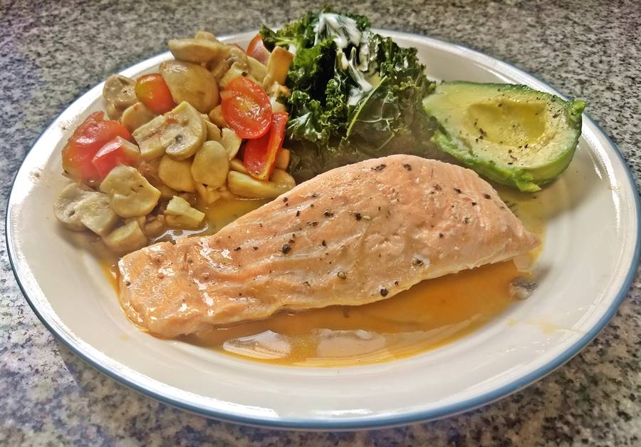 salmon, avocado, kale and wok veggies on a plate