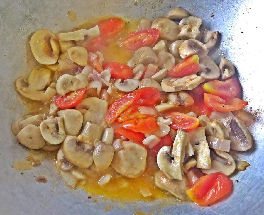 wok veggies are ready tomatoes, mushrooms and shallots simering in the wok
