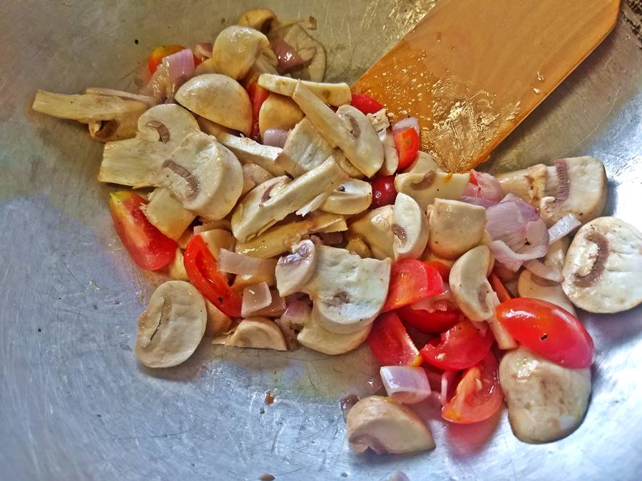 veggies in wok mushroom, tomato and shallot in the wok