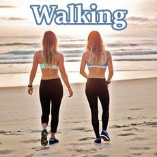 2 woman walking along a beach