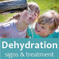 two yound girls smiling and driniing running water