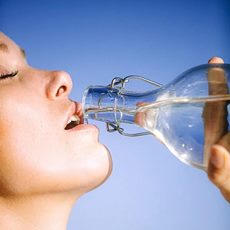 young woman drinking water from a bottle