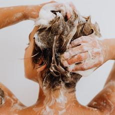 woman back to us, shampooing hair