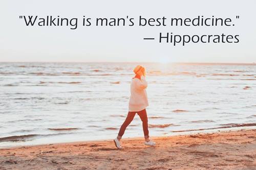 woman walks along a beach in the sun, text quotes: WALKING IS MAN’s BEST MEDICINE - HYPPOCRATES