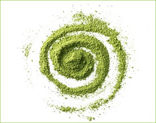 twirl of fine green matcha powder against white background