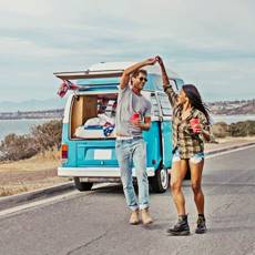 couple dancing by van on a road trip