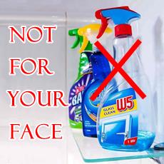 glass cleaner bottles on a shelf crossed out in red