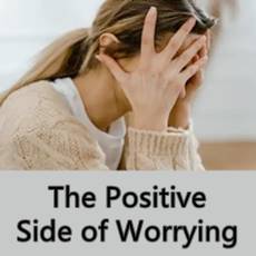 woman holding head with hands